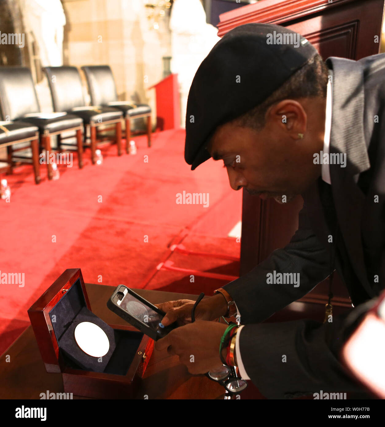 Film maker Spike Lee takes a photo of the Congressional Gold Medal  before a Congressional Gold Medal ceremony which was posthumously presented to victims of the 1963 Birmingham bombing, at the U.S. Capitol, in Washington on September 10, 2013.  The medal is awarded in recognition of victims Addie Mae Collins, Denise McNair, Carole Robertson and Cynthia Wesley, and how their sacrifice served as a catalyst for the Civil Rights Movement.  UPI/Molly Riley Stock Photo