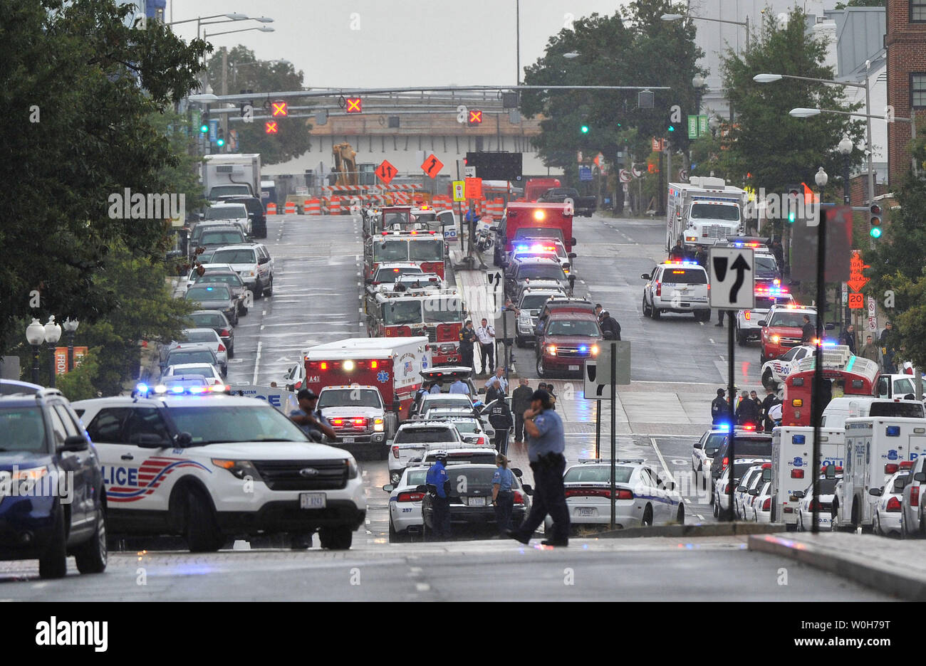 Emergency vehicles line the street near the Navy Yard, a huge complex of buildings located along the Anacostia River waterfront on September 16, 2013 in Washington, DC. A gunman killed at least four and wounded others before being killed by police in a running gun battle.     UPI/Kevin Dietsch Stock Photo