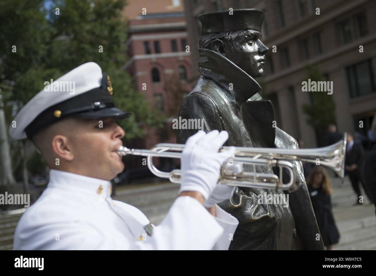 A bugler plays taps during a ceremony at the Navey Memorial where Defense Secretary Chuck Hagel and Chairman of the Joint Chiefs of Staff Gen. Martin Dempsey placed a wreath in honor of the victims of yesterday's Navy Yard shooting, in Washington, D.C. on September 17, 2013. Yesterday morning alleged gunman Aaron Alexis opened fire on the Naval complex killing 12.  UPI/Kevin Dietsch Stock Photo