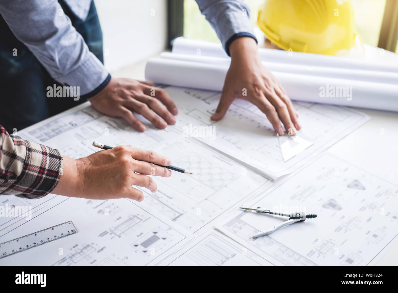 Construction engineering or architect discuss a blueprint while