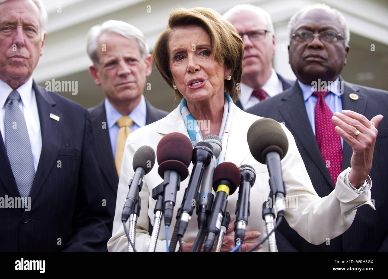 House Minority Leader Nancy Pelosi (D-CA) speaks to the media following a meeting with President Barack Obama on the debt limit and reopening the government at the White House in Washington, D.C. on October 15, 2013. Pelosi was joined by House Minority Whip Steny Hoyer (D-MD) (L), Rep. Steve Israel (D-NY) (2nd-L), Rep. Steve Crowley (D-NY) (2nd-R) and Rep. Jame Clyburn (R-SC). UPI/Kevin Dietsch Stock Photo