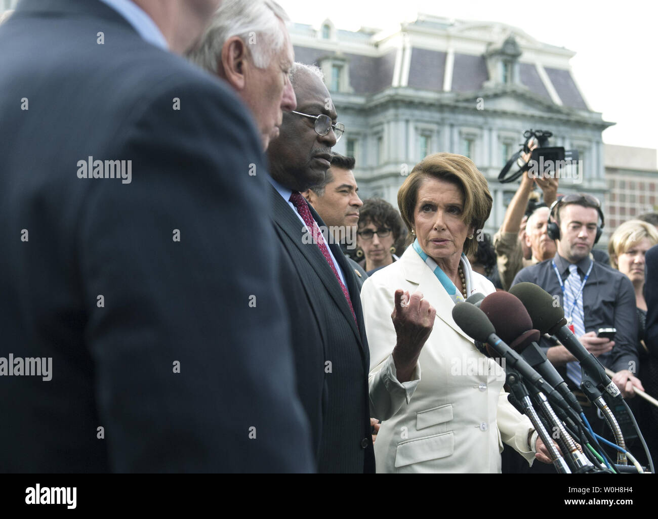 House Minority Leader Nancy Pelosi (D-CA) speaks to the media following a meeting with President Barack Obama on the debt limit and reopening the government at the White House in Washington, D.C. on October 15, 2013. Pelosi was joined by House Minority Whip Steny Hoyer (D-MD) (L), Rep. Jame Clyburn (R-SC) and Rep. Xavier Becerra (D-CA). UPI/Kevin Dietsch Stock Photo