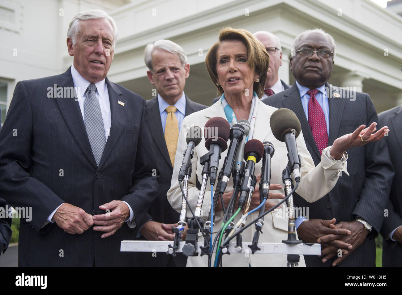 House Minority Leader Nancy Pelosi (D-CA) speaks to the media following a meeting with President Barack Obama on the debt limit and reopening the government at the White House in Washington, D.C. on October 15, 2013. Pelosi was joined by House Minority Whip Steny Hoyer (D-MD) (L), Rep. Steve Israel (D-NY) (2nd-L), Rep. Steve Crowley (D-NY) (2nd-R) and Rep. Jame Clyburn (R-SC). UPI/Kevin Dietsch Stock Photo