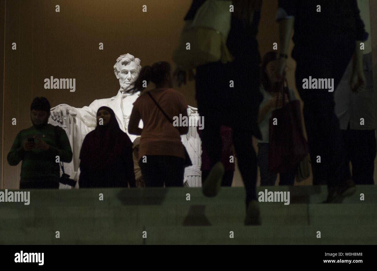 Tourists visit the Lincoln memorial on the first night that the Memorial was reopened after a 16-day partial government shutdown closed all National Parks and Monuments, on October 17, 2013 in Washington, DC. A bipartisan funding bill was passed by the House and the Senate and signed by President Obama to reopened the government and raise the debt limit. UPI/Kevin Dietsch Stock Photo