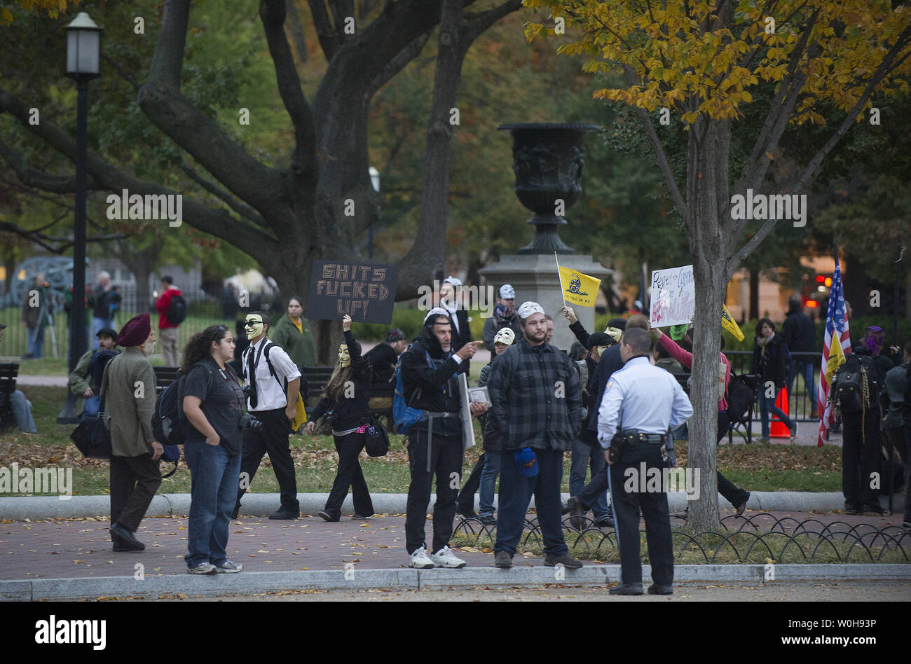 Protester gather in Lafayette Park following a protest outside of the White House in Washington, D.C. on November 5, 2013. Protesters gathered in Washington, D.C. and around the world as part of the Million Mask March to protest against government corruption and corporate greed. UPI/Kevin Dietsch Stock Photo