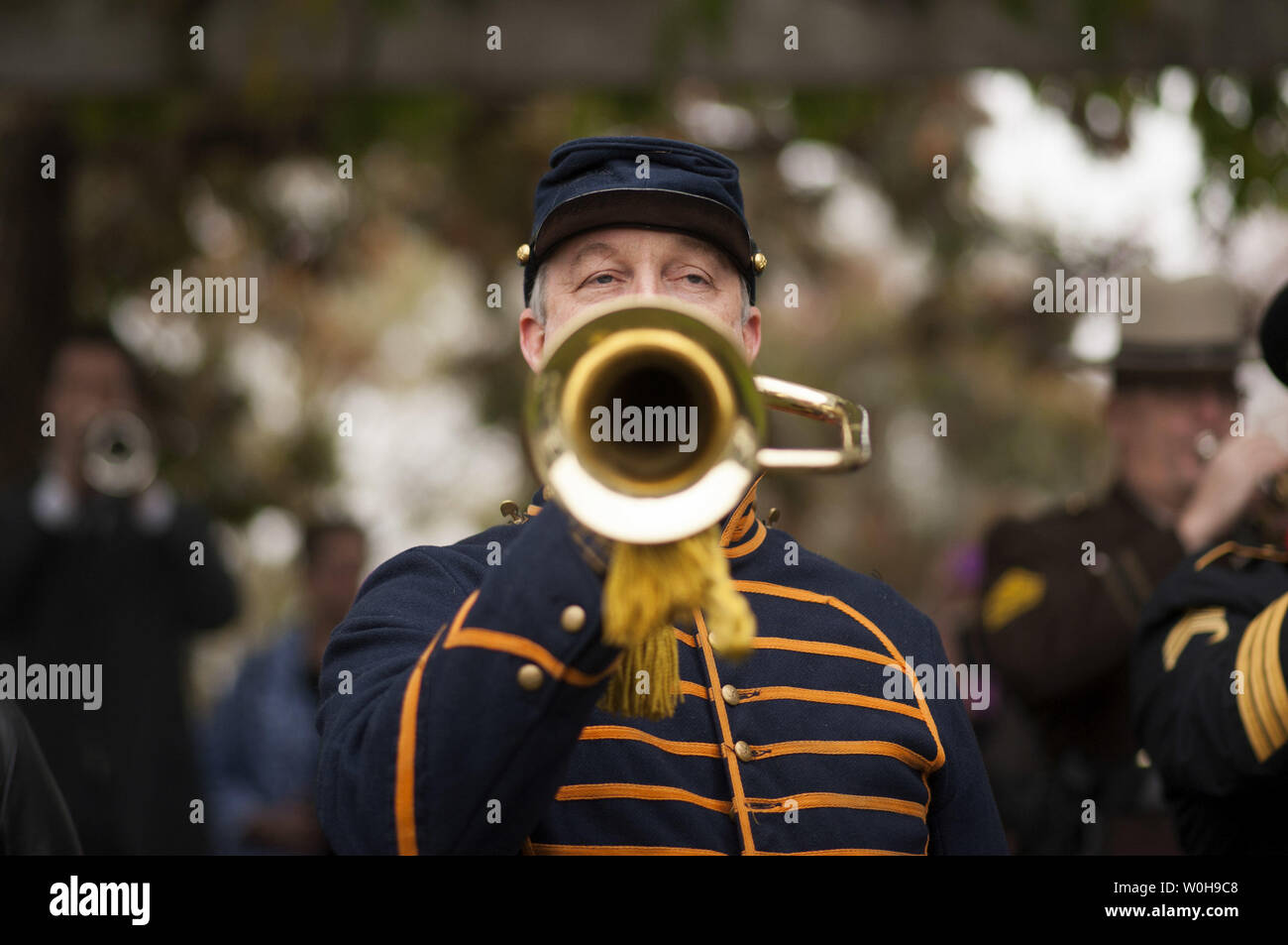 A bugler plays Taps with fellow buglers during the Bugle Call to