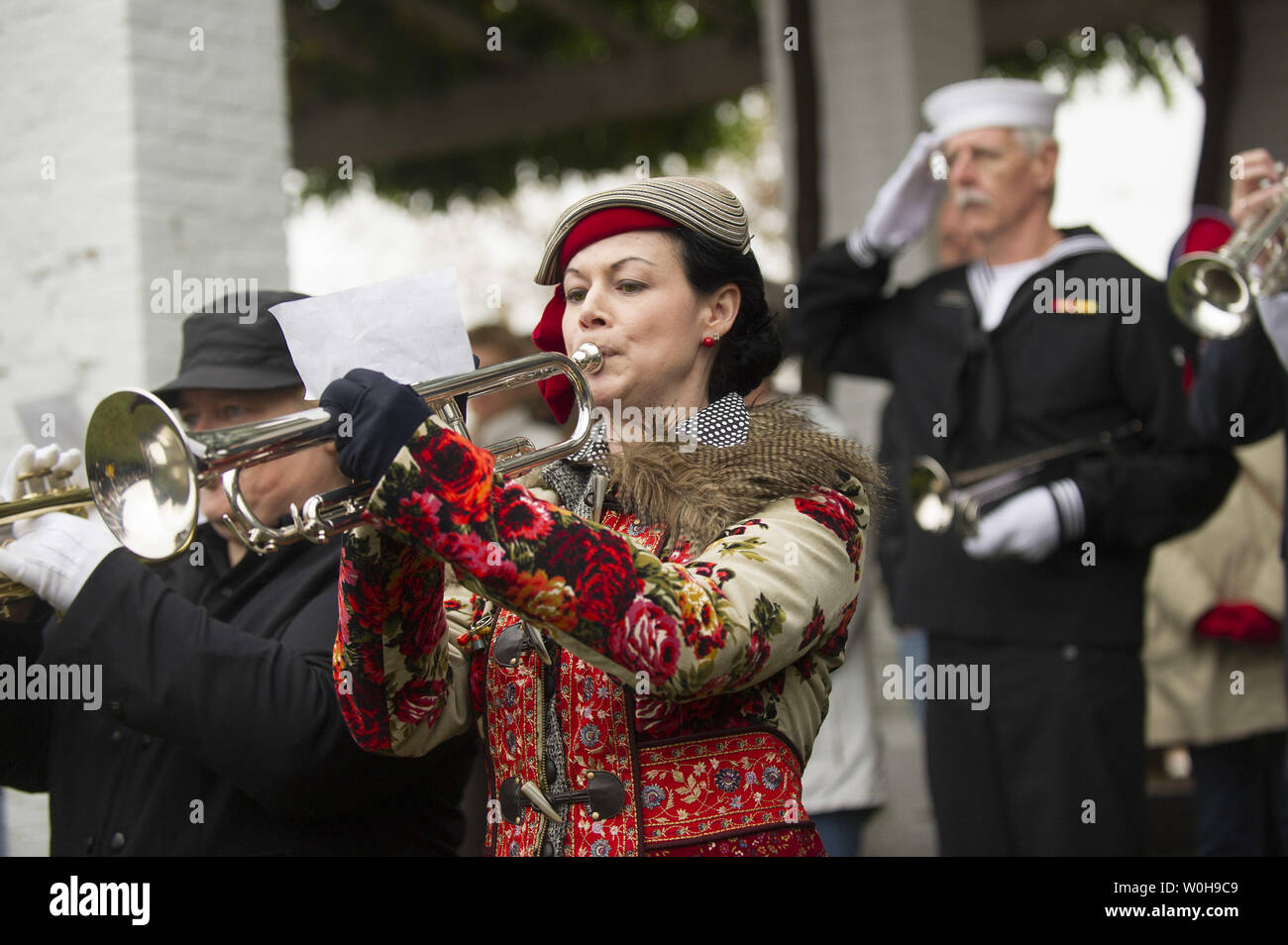Lori Crandall of Arlington, Virginia plays Taps with fellow buglers