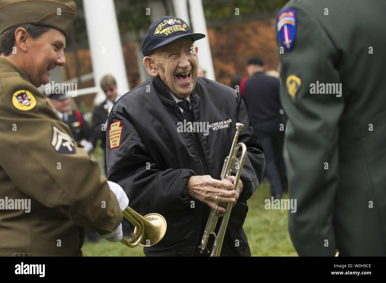 World War II veteran Ed Ruffennach laughs with fellow buglers during