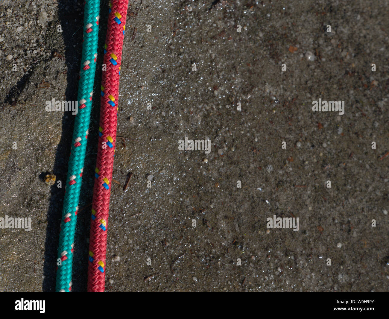 Pair of climbing ropes in detail with exposed sandstone rock background ...