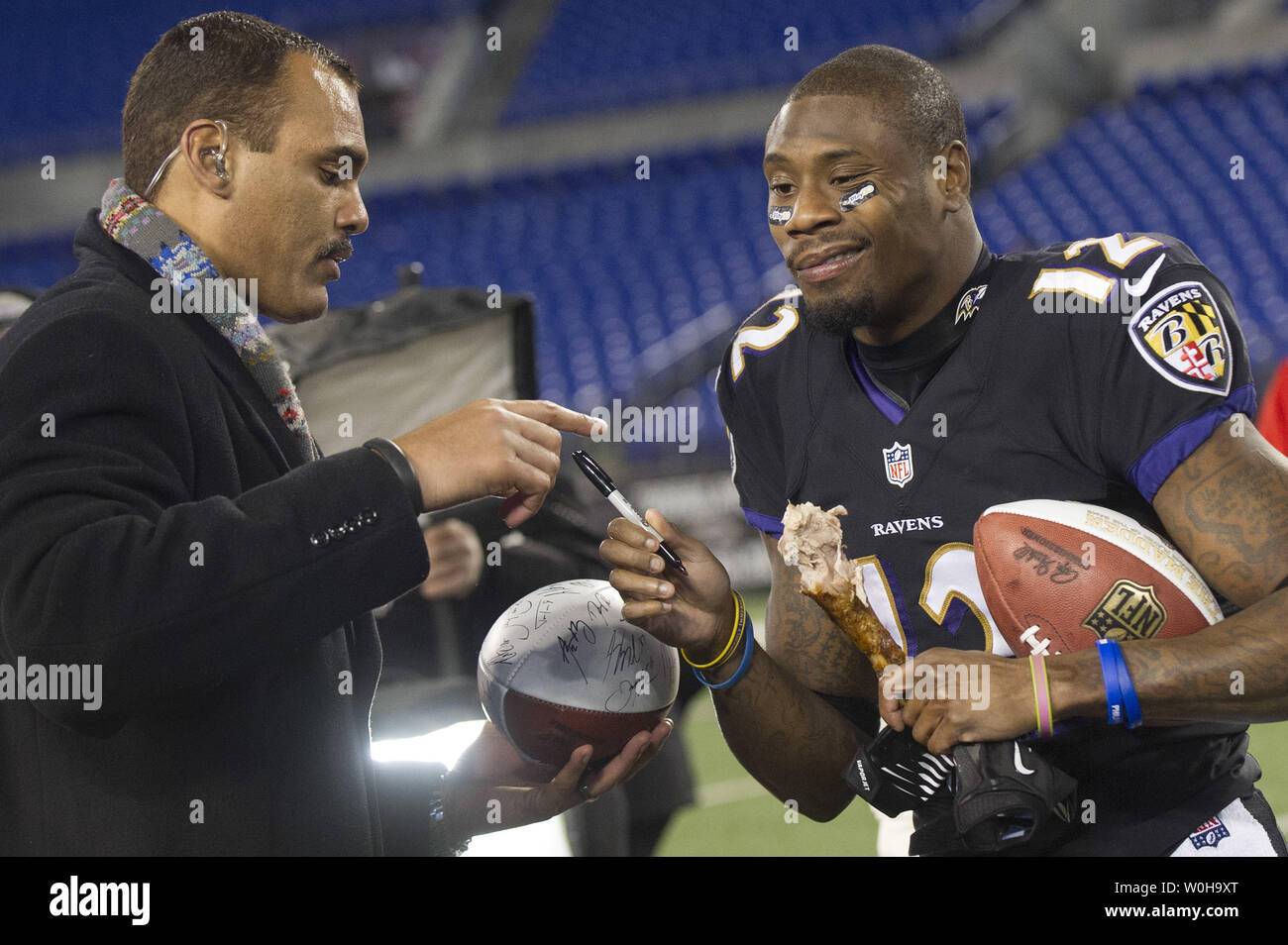 Baltimore Ravens wide receiver Jacoby Jones signs an autograph as he holds  a turkey leg after the Ravens defeated the Pittsburgh Steelers 22-20 on  Thanksgiving day at M&T Bank Stadium in Baltimore