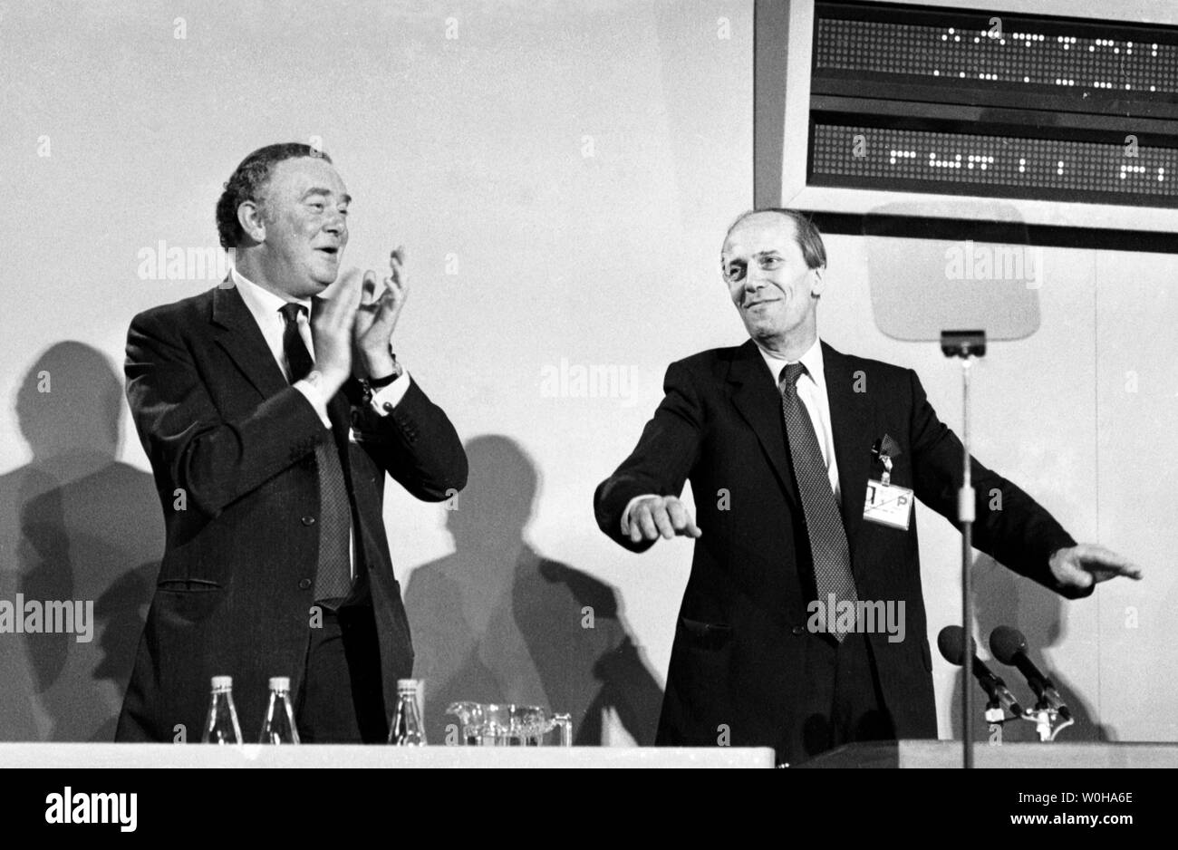 Tory party chairman Norman Tebbit (r) appeals for quiet during an enthusiastic reception to his speech at the party's conference in Blackpool. Tory party vice-chairman Peter Morrison (l) stands applauding.  *WIREPHOTO Stock Photo