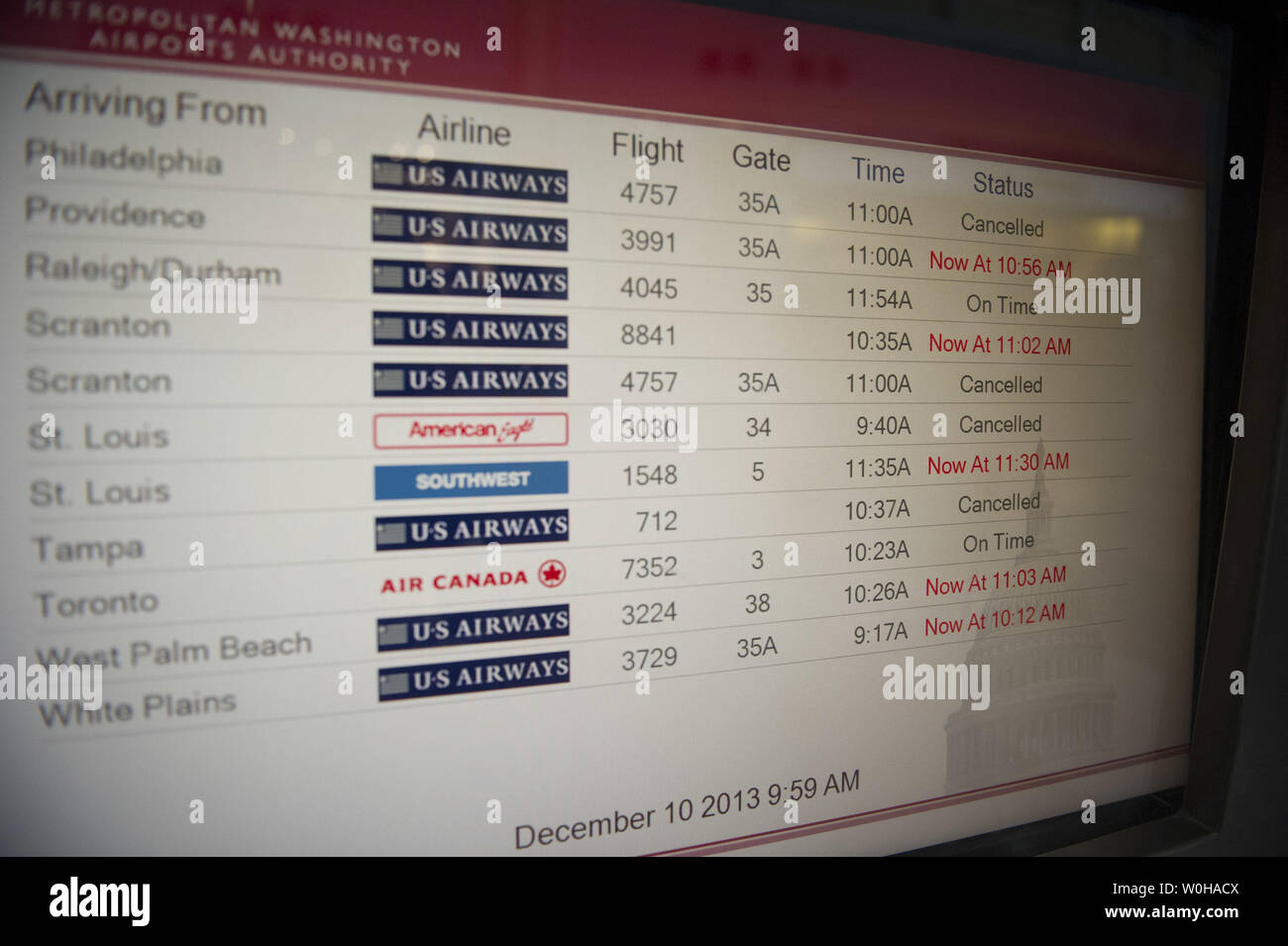 A monitor displays flight delays and cancelations at Ronald Reagan National Airport in Arlington, Virginia, December 10, 2013. The National Weather Service issued a winter storm warning for the Eastern Seaboard, including Baltimore, Washington, Philadelphia and Wilmington, DE. Snow accumulations of 3 to 6 inches are expected. UPI/Kevin Dietsch Stock Photo