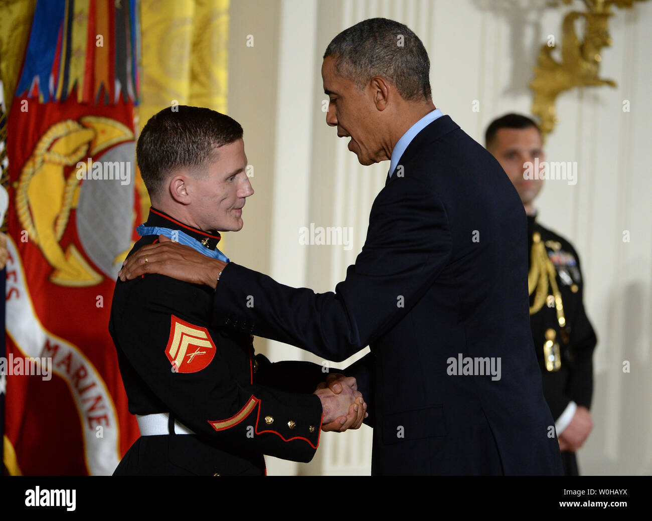 President Barack Obama awards the Medal of Honor to retired Marine William 'Kyle' Carpenter during a ceremony in the East Room of the White House in Washington, DC on June 19, 2014.  Carpenter, 24, of Gilbert, South Carolina was awarded the nation's highest award for gallantry for covering a grenade with his body to save a Marine's life in Afghanistan in 2010.    UPI/Pat Benic Stock Photo