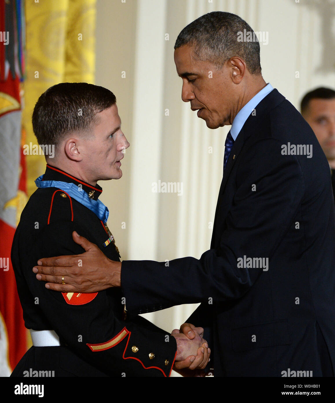 President Barack Obama awards the Medal of Honor to retired Marine William 'Kyle' Carpenter during a ceremony in the East Room of the White House in Washington, DC on June 19, 2014.  Carpenter, 24, of Gilbert, South Carolina was awarded the nation's highest award for gallantry for covering a grenade with his body to save a Marine's life in Afghanistan in 2010.    UPI/Pat Benic Stock Photo