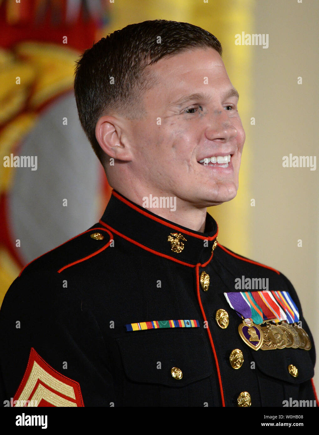 Retired Marine William 'Kyle' Carpenter smiles during comments by President Barack Obama prior to awarding him the  Medal of Honor in the East Room of the White House in Washington, DC on June 19, 2014.  Carpenter, 24, of Gilbert, South Carolina was awarded the nation's highest award for gallantry for covering a grenade with his body to save a Marine's life in Afghanistan in 2010.    UPI/Pat Benic Stock Photo