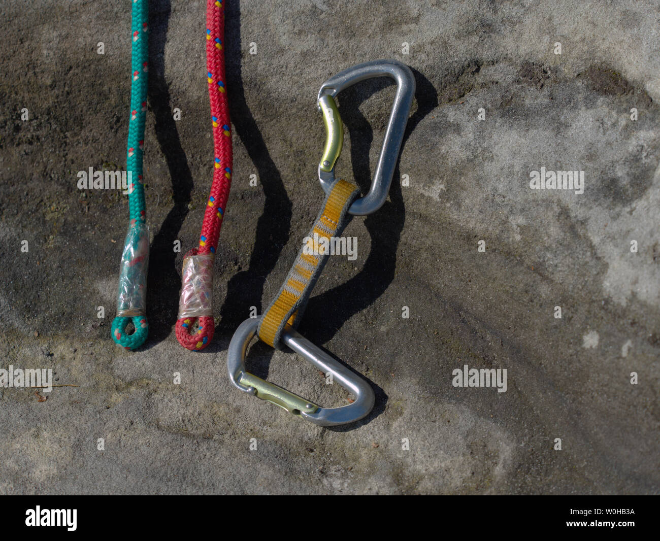 Hank sling carabiners at used and worn red and green ropes. Old used