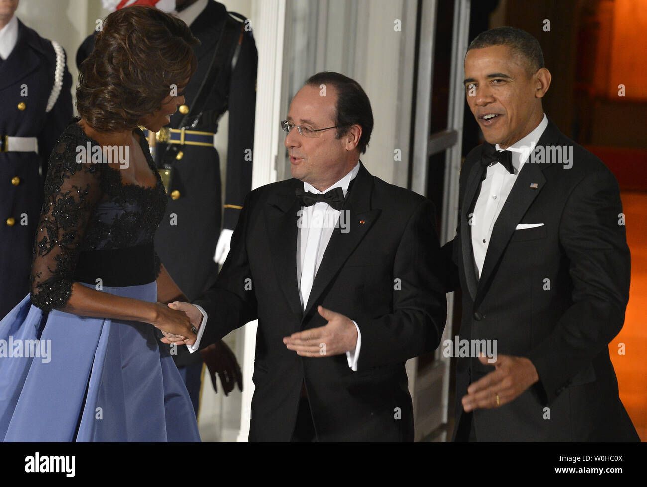 US President Barack Obama (R) and First Lady Michelle Obama welcome French President Francois Hollande for a State Dinner at the White House, February 11, 2014, in Washington, DC. Hollande is on a State Visit to strengthen bilateral, trade, economic and security ties.       UPI/Mike Theiler Stock Photo