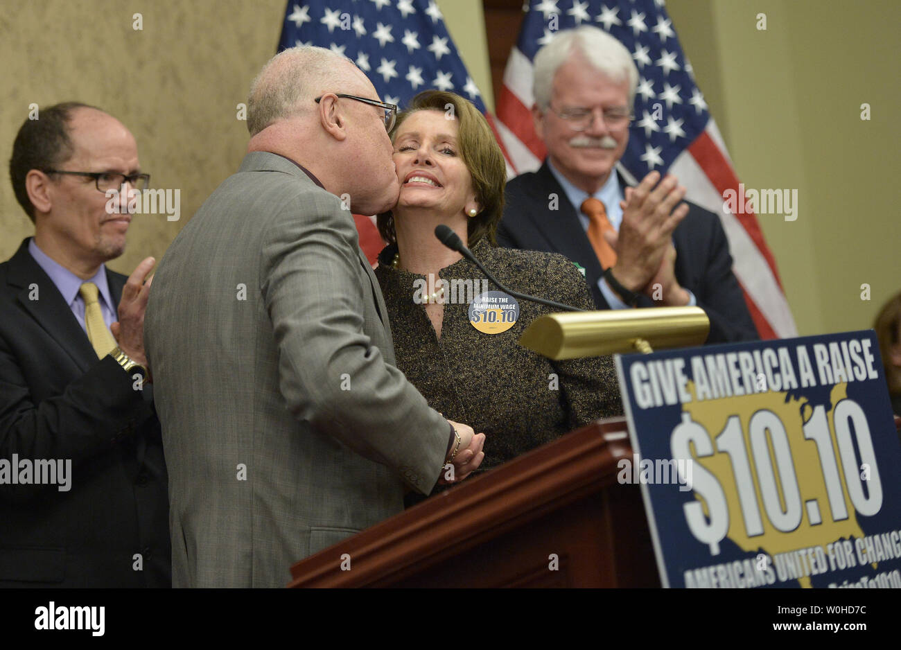 Lee Saunders, president of AFSCME, kisses House Minority Leader Nancy Pelosi, D-Calif,. before speaking at a press conference on raising the minimum wage to $10.10 per hour, on Capitol Hill in Washington, D.C. on April 3, 2014. Pelosi was joined by Labor Secretary Thomas Perez, Rep. George Miller, D-Calif. UPI/Kevin Dietsch Stock Photo