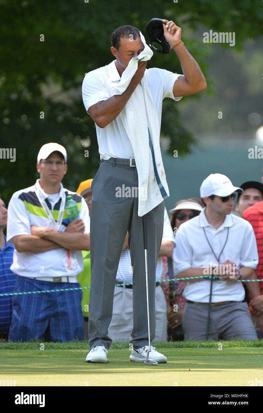 Tiger Woods wipes sweat from his face during the second round of the Quicken Loans Nationals at Congressional Country Club, in Potomac, Maryland on June 27, 2014.  UPI/Kevin Dietsch Stock Photo