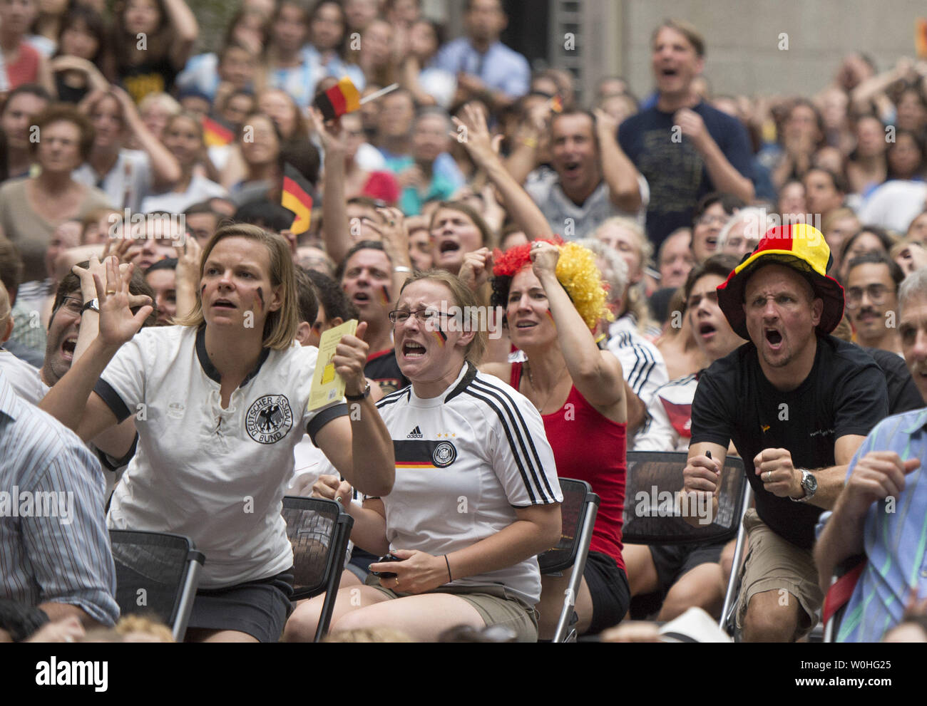 German fans react as they watch the 2014 World Cup final between Germany and Argentina during a watch party held at the Smithsonian Portrait Gallery, in Washington, D.C. on July 13, 2014.  UPI/Kevin Dietsch Stock Photo
