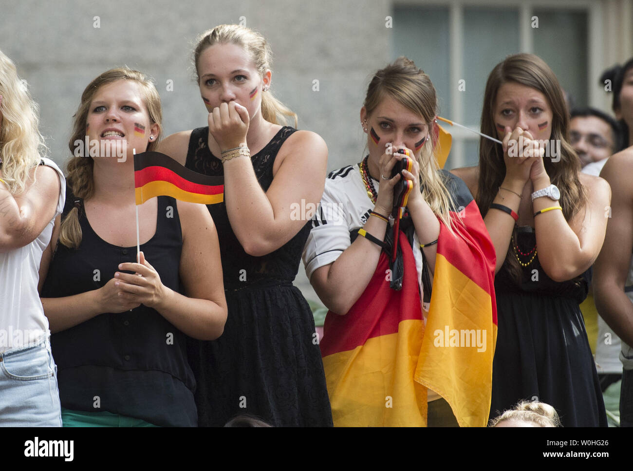 German fans react as they watch the 2014 World Cup final between Germany and Argentina during a watch party held at the Smithsonian Portrait Gallery, in Washington, D.C. on July 13, 2014.  UPI/Kevin Dietsch Stock Photo