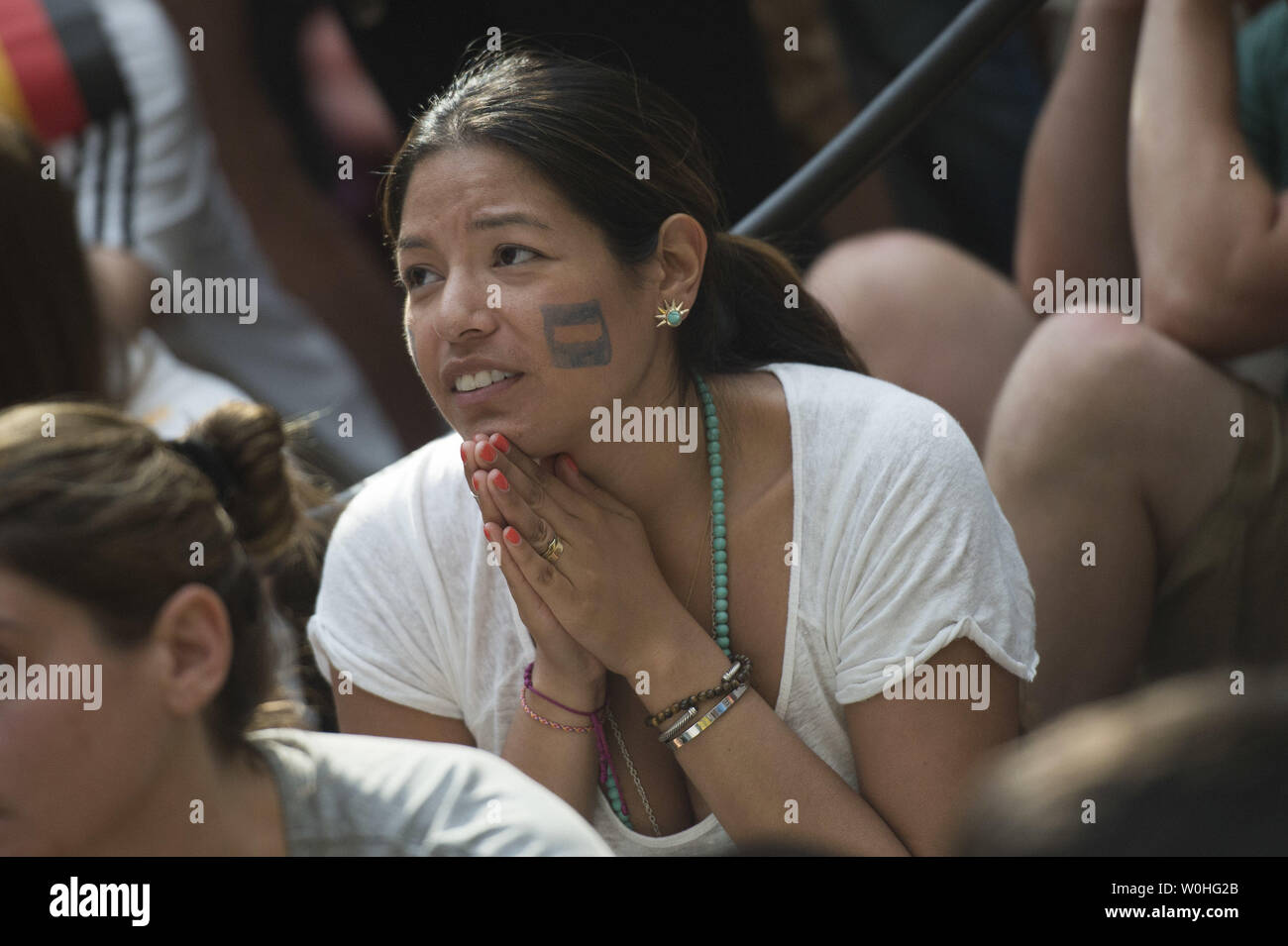 An Argentina fan watches as her team plays Germany in the 2014 World Cup final, during a watch party held at the Smithsonian Portrait Gallery, in Washington, D.C. on July 13, 2014.  UPI/Kevin Dietsch Stock Photo