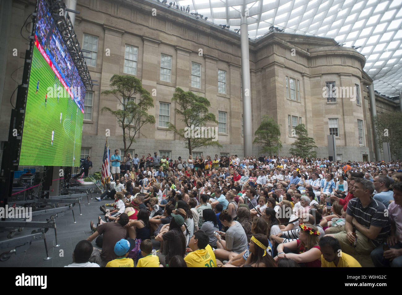 Fans gather to watch the 2014 World Cup final between Germany and Argentina during a watch party held at the Smithsonian Portrait Gallery, in Washington, D.C. on July 13, 2014.  UPI/Kevin Dietsch Stock Photo