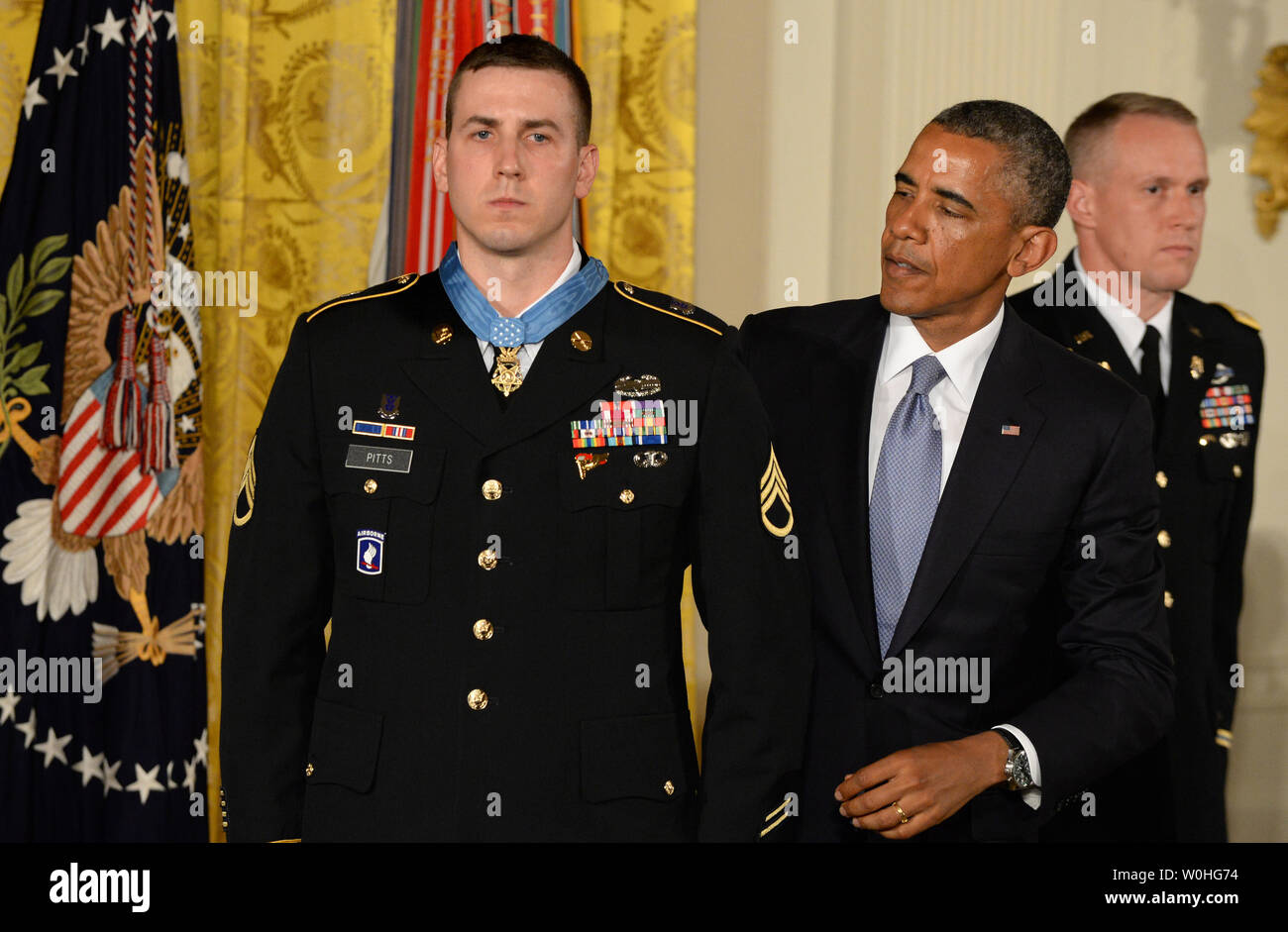 U.S. President Barack Obama presents the Medal of Honor to former Army Staff Sergeant Ryan Pitts during a ceremony in the East Room of the White House on July 21, 2014.  Pitts, from the 2nd Platoon, Chosen Company, 2nd Battalion (Airborne), 503rd Infantry Regiment, 173rd Airborne Brigade, was awarded the Nation's highest military honor for his courageous actions during combat operations at Vehicle Patrol Base Kahler in Kunar Province, Afghanistan on July 13, 2008.       UPI/Pat Benic Stock Photo