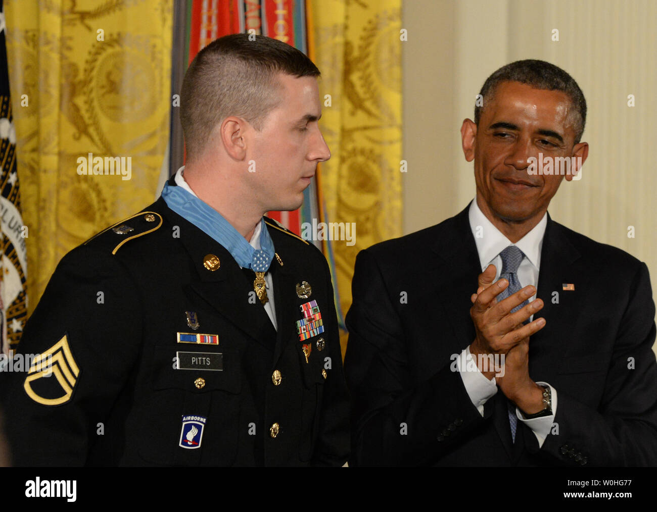 U.S. President Barack Obama applauds after presenting the Medal of Honor to former Army Staff Sergeant Ryan Pitts during a ceremony in the East Room of the White House on July 21, 2014.  Pitts, from the 2nd Platoon, Chosen Company, 2nd Battalion (Airborne), 503rd Infantry Regiment, 173rd Airborne Brigade, was awarded the Nation's highest military honor for his courageous actions during combat operations at Vehicle Patrol Base Kahler in Kunar Province, Afghanistan on July 13, 2008.       UPI/Pat Benic Stock Photo