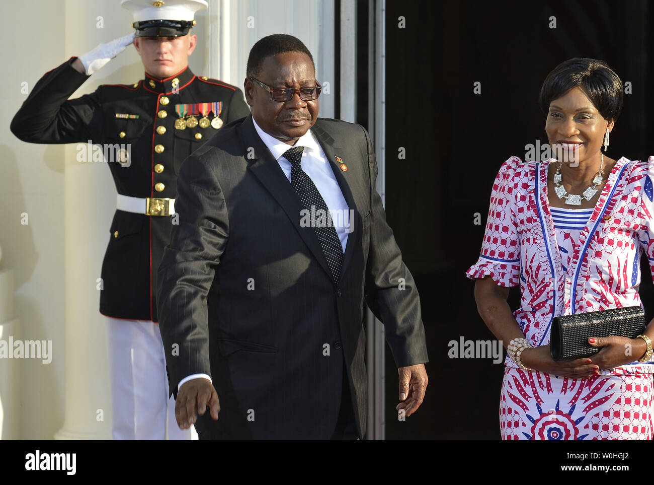 Malawi's President Arthur Peter Mutharika and First Lady Gertrude Hendrina Mutharika greet the press as they arrive at the White House for a State Dinner on behalf of the US-Africa Leaders Summit, August 5, 2014, in Washington, DC. Nearly 50 heads of state and government from Africa are attending the summit to advance business, agriculture, development and infrastructure interests on the continent.              UPI/Mike Theiler Stock Photo