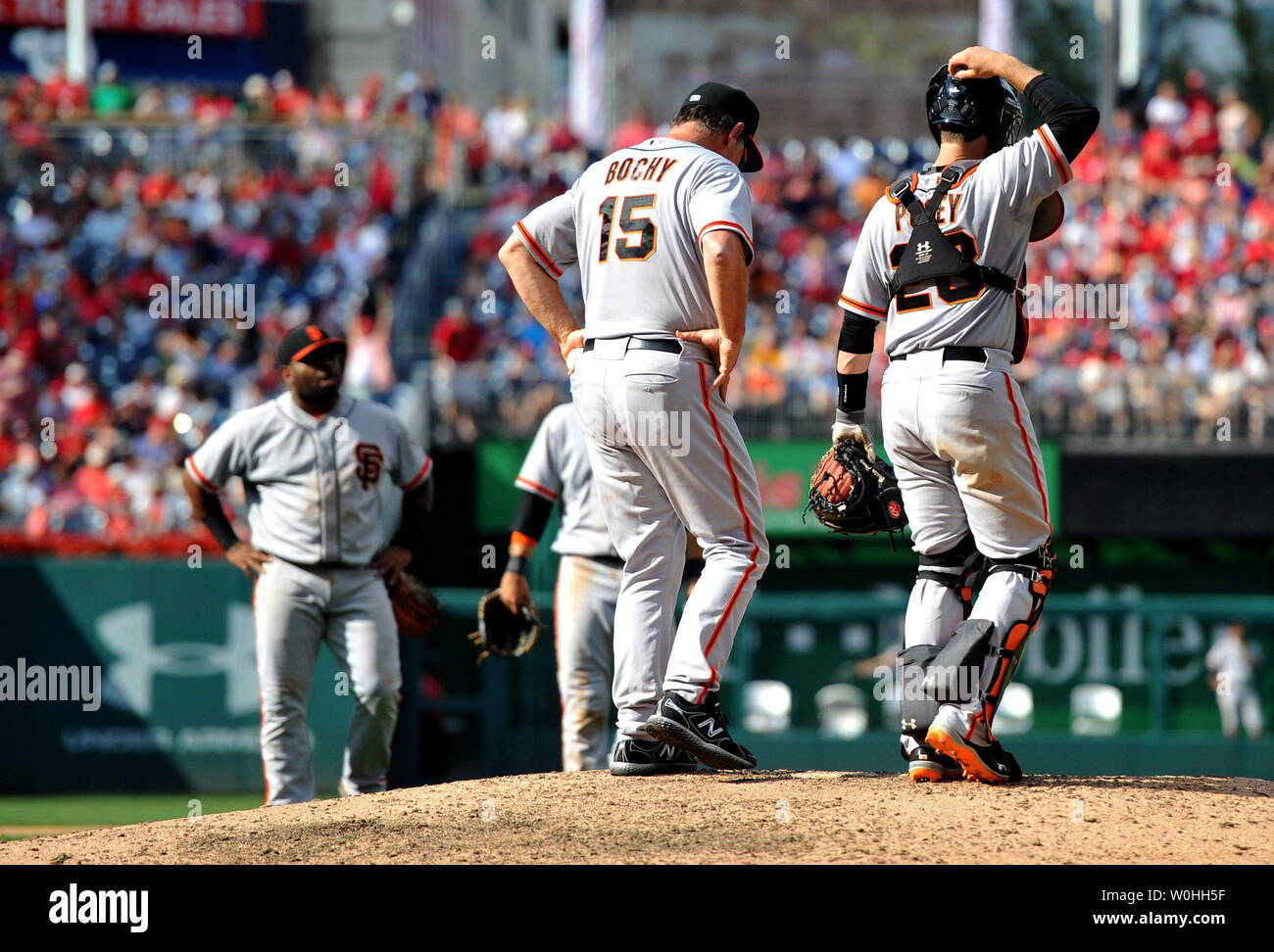 San Francisco Giants manager Bruce Bochy waits on the mound with catcher Buster Posey after reliving pitcher Javier Lopez, at Nationals Park in on August 24, 2014 in Washington, D.C. UPI/Kevin Dietsch Stock Photo