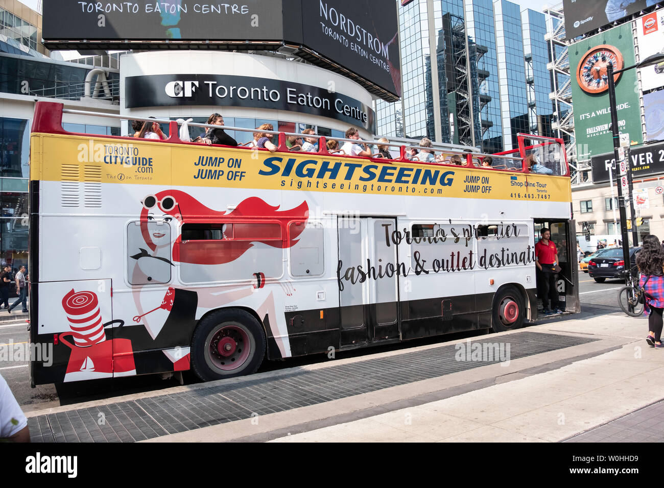 Tourist Bus waiting to depart in Toronto, Ontario. Canada, city, downtown, summer festival on Dundas Square and Yonge Street Stock Photo