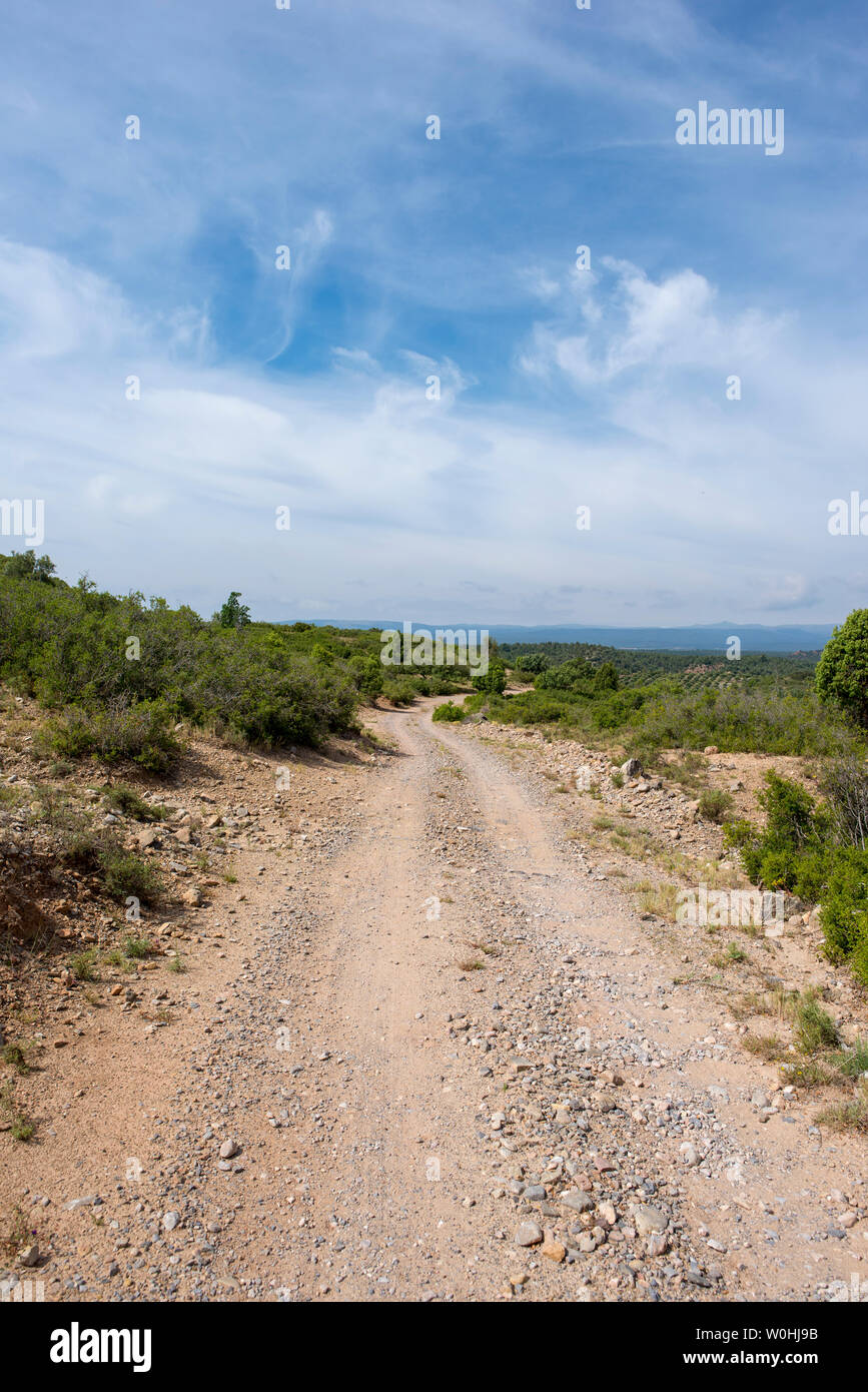 Rural road between mountains of the Sierra de Gudar, Valbona, Spain Stock Photo
