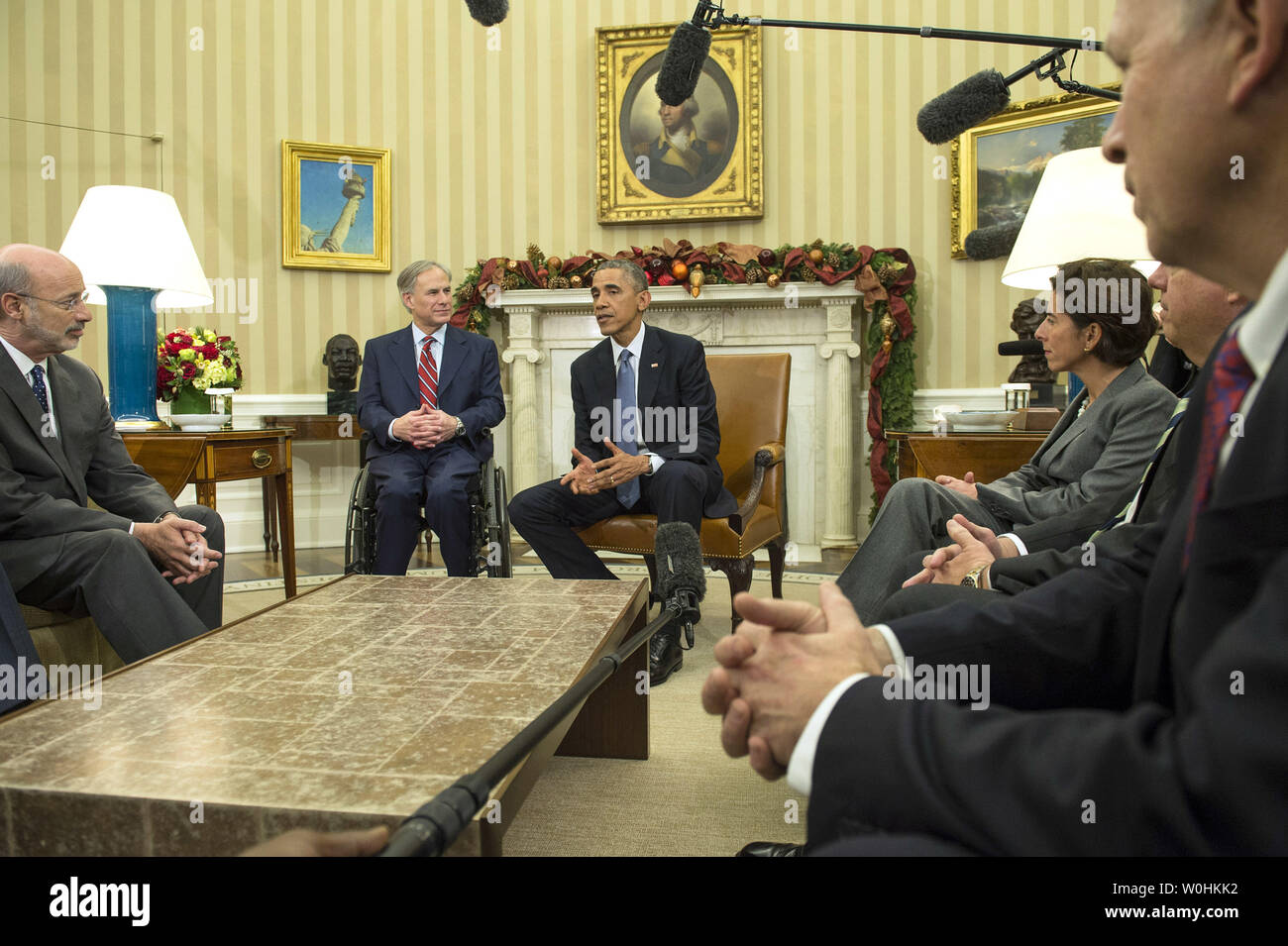 President Barack Obama, seated next to Governor-elect Greg Abbott (R-TX), speaks to reporters as he meets with newly elected governors in the Oval Office of the White House on December 5, 2014. Obama met with Governor-elect Charlie Baker (R-MA), Governor-elect Bruce Rauner (R-IL), Governor-elect Tom Wolf (D-PA), Governor-elect Gina Raimondo (D-RI), Governor-elect Larry Hogan (R-MD) and Gov. Bill Walker (I-AK). UPI/Kevin Dietsch Stock Photo