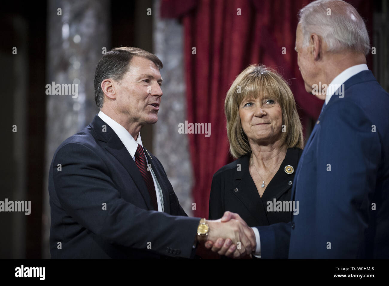 Vice President Joe Biden (right) administers the Senate oath to Senator Mike Rounds (R-SD) as Rounds' wife, Jean, holds the Bible and looks on during a ceremonial re-enactment swearing-in ceremony on January 6, 2015 in Washington, D.C. Photo by Pete Marovich/UPI Stock Photo