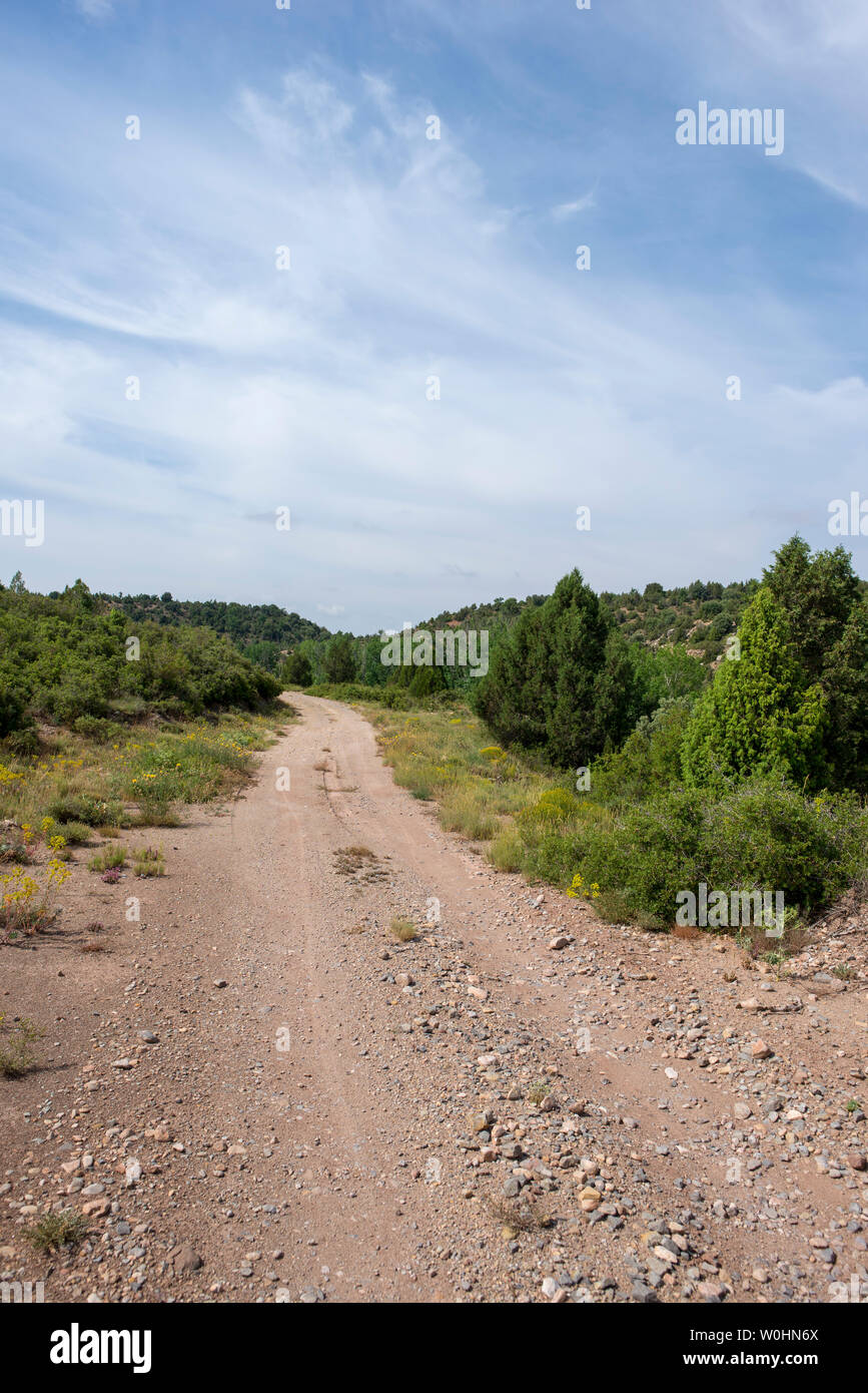 Rural road between mountains of the Sierra de Gudar, Valbona, Spain Stock Photo