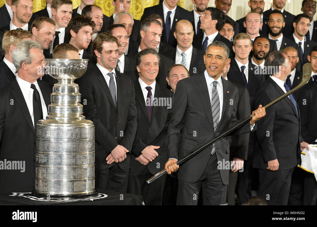 U.S. Barack Obama holds a souvenir hockey stick presented by National  Hockey League Stanley Cup Champions