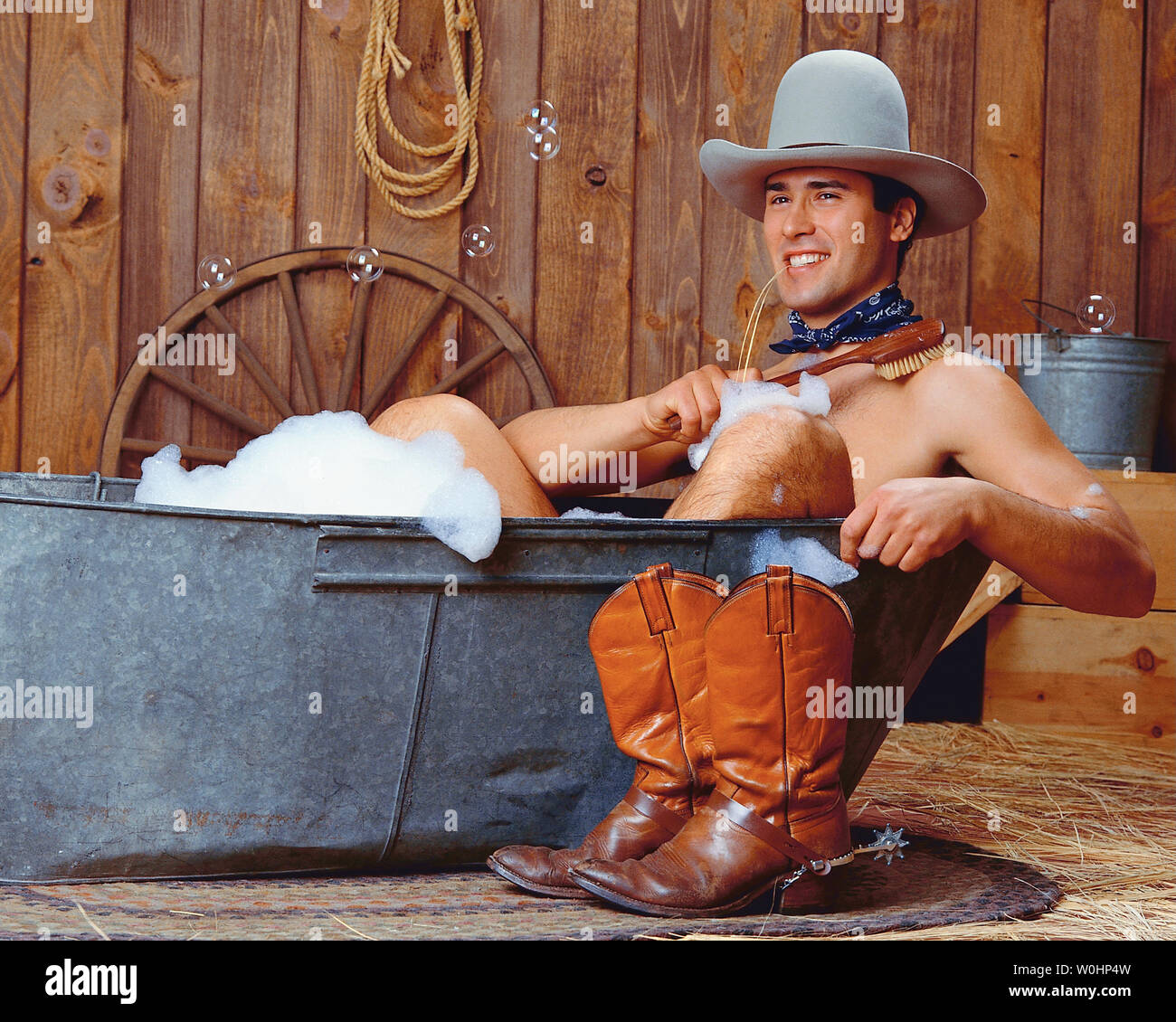 Cowboy sitting in a bathtub Stock Photo Alamy