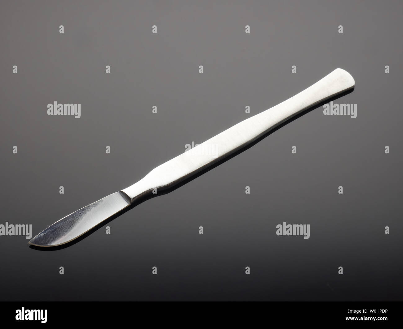 Dental medical knife on gray gradient background Stock Photo Alamy