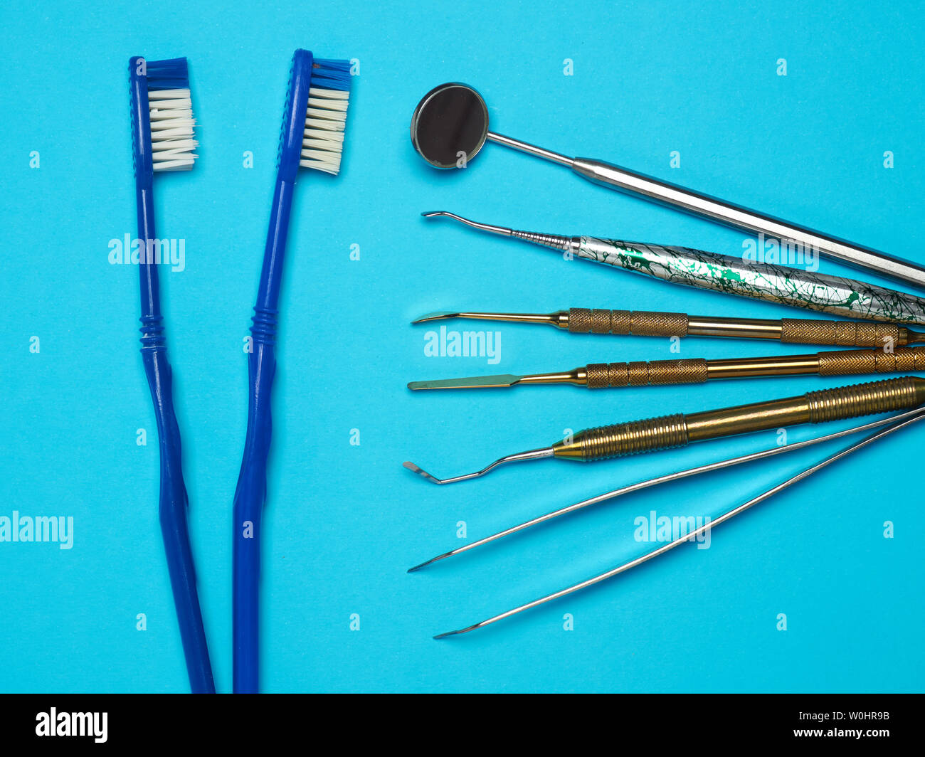 Professional dental tools on blue background. Dental health concept