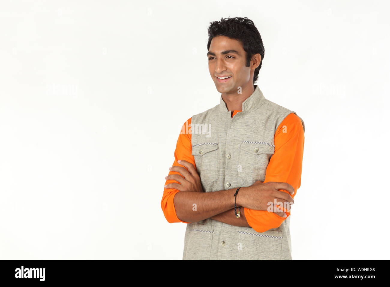 Indian young man smiling with his arms crossed Stock Photo - Alamy