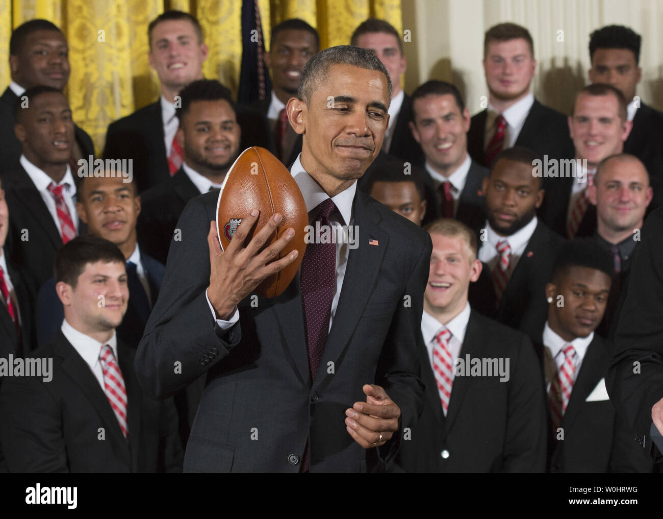 President Barack Obama holds a football as he honors the 2015 College Football Playoff National Champions Ohio State University Buckeyes in the East Room at the White House in Washington, D.C. on April 20, 2015.  Photo by Kevin Dietsch/UPI Stock Photo