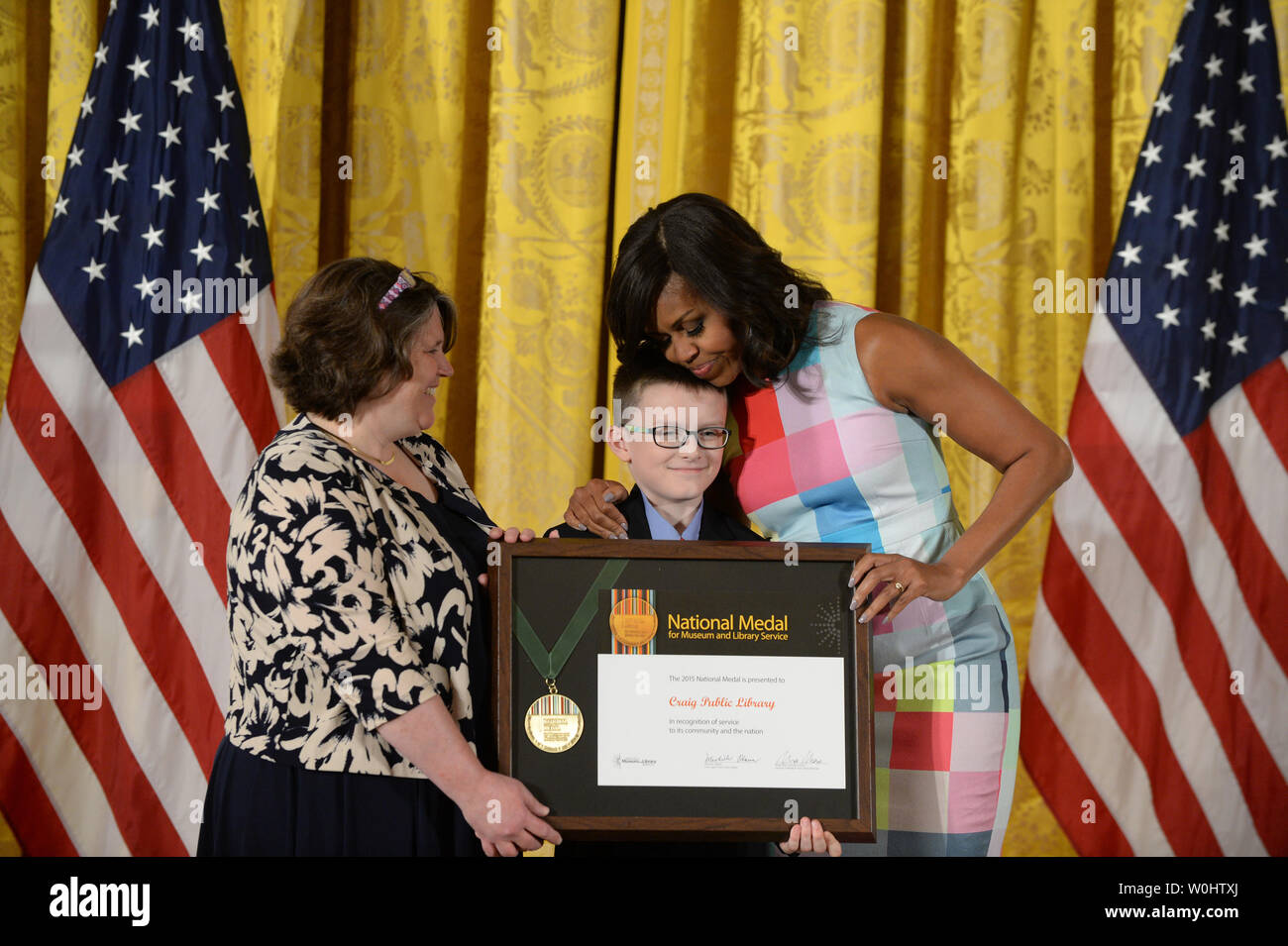 First Lady Michelle Obama hugs Colin Rice, community member of the
