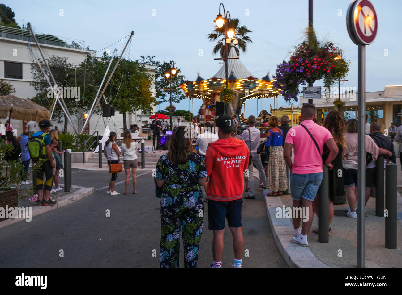 People wander in the street at twilight, Cassis, Bouches-du-Rhone, France Stock Photo