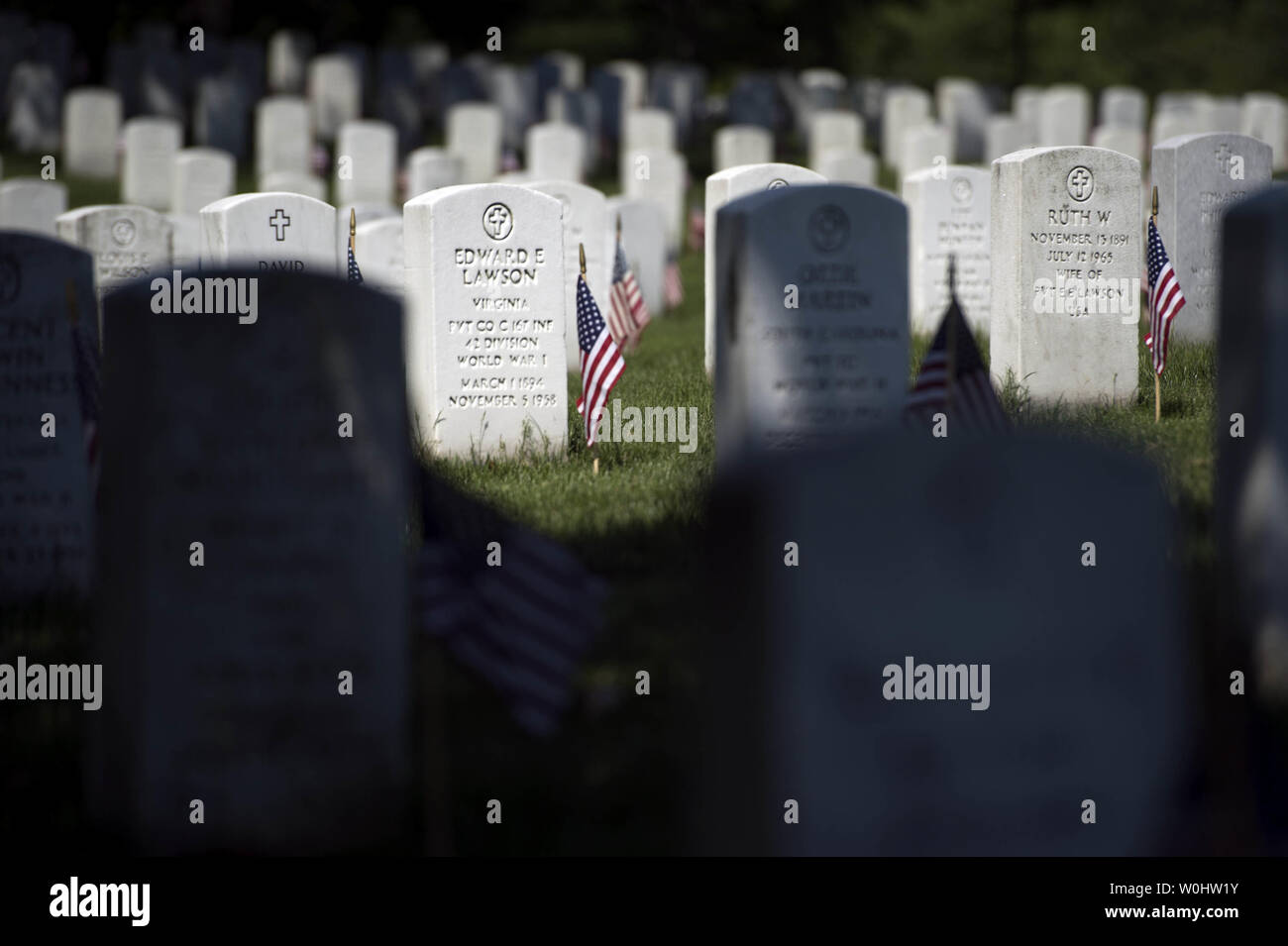 Flags are seen at gravestones at Arlington National Cemetery on ...