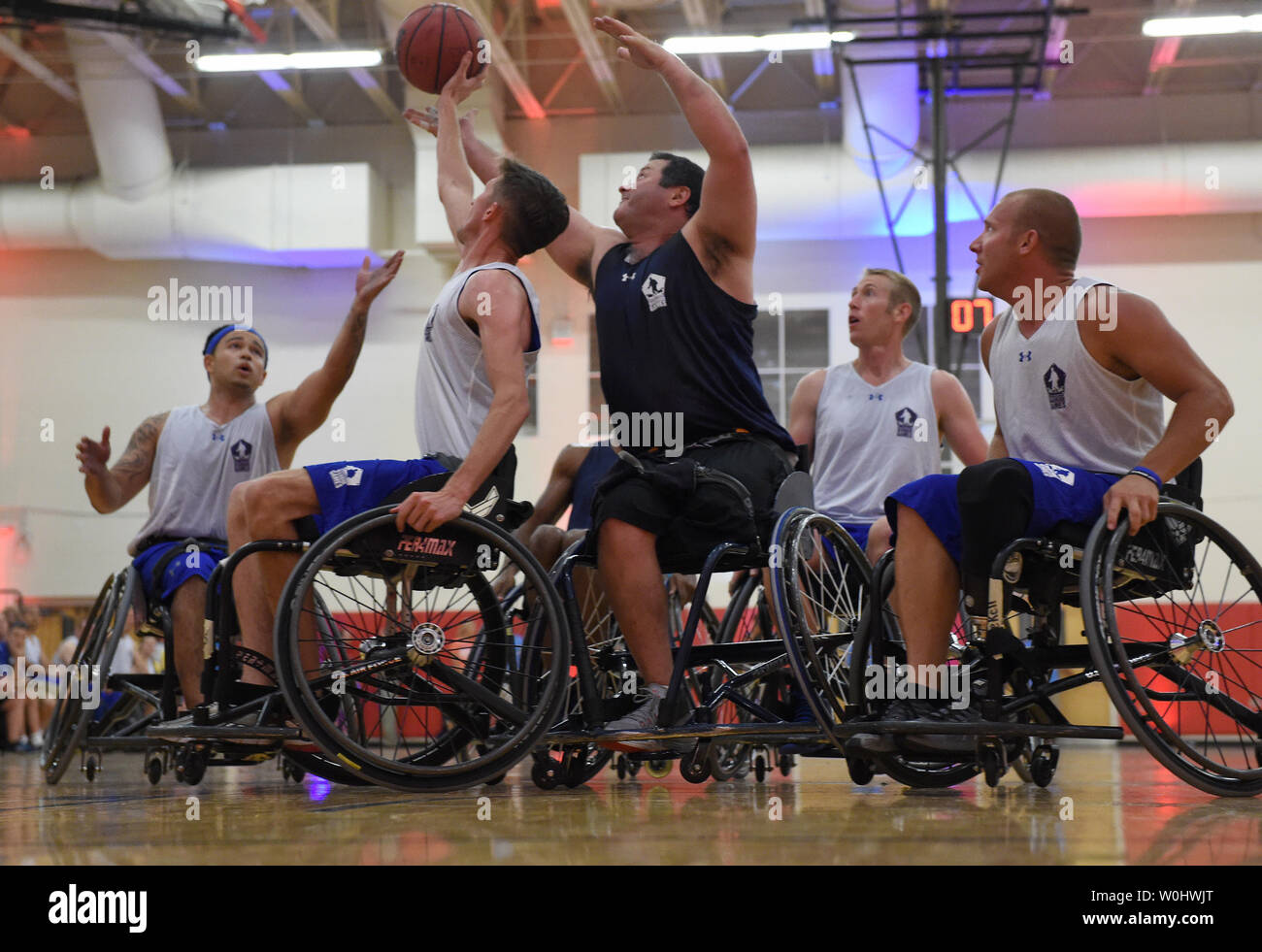 Players scramble for the ball in the game between Team Navy andTeam Air Force during the Wheelchair Basketball game of the 2015 Department Of Defense Warrior Games at the United States Marine Corps base in Quantico, Va.,  June 22, 2015.  Photo by Molly Riley/UPI Stock Photo