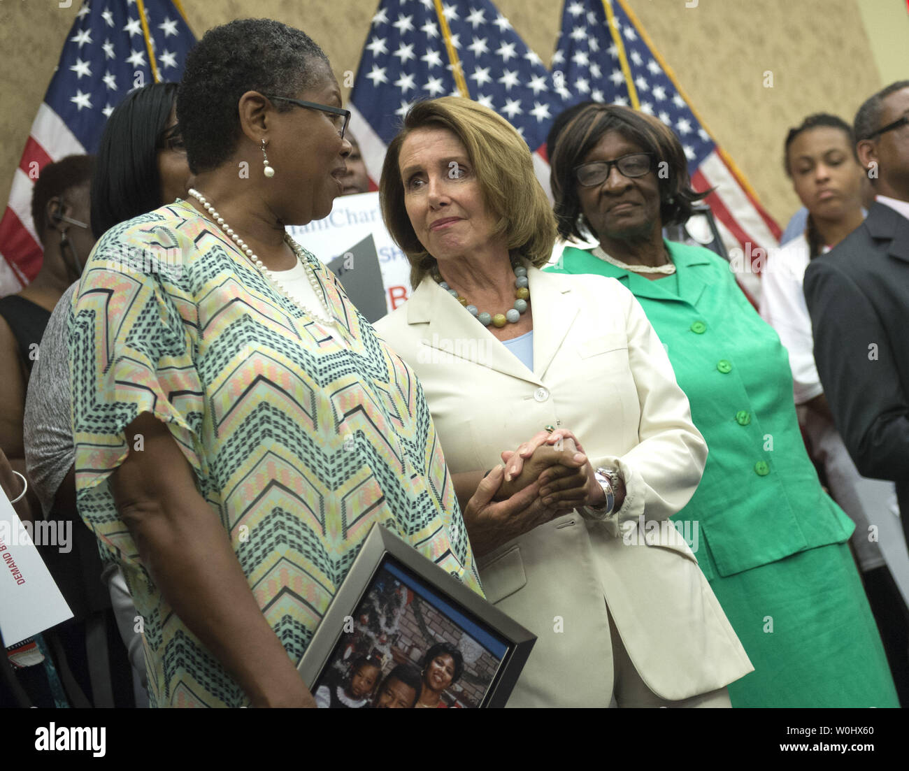 House Minority Leader Nancy Pelosi, D-Calif., holds hands with Sherialyn Byrdsong, whose husband Ricky was shot and kill in 1999, during a press conference on a bill that would extend Brady background check to all gun sales including online and at gun shows, in Washington, D.C. on July 8, 2015. The request to bring the bill, H.R. 1217, to the floor for a vote comes in the wake of the recent Charleston church shooting. Photo by Kevin Dietsch/UPI Stock Photo