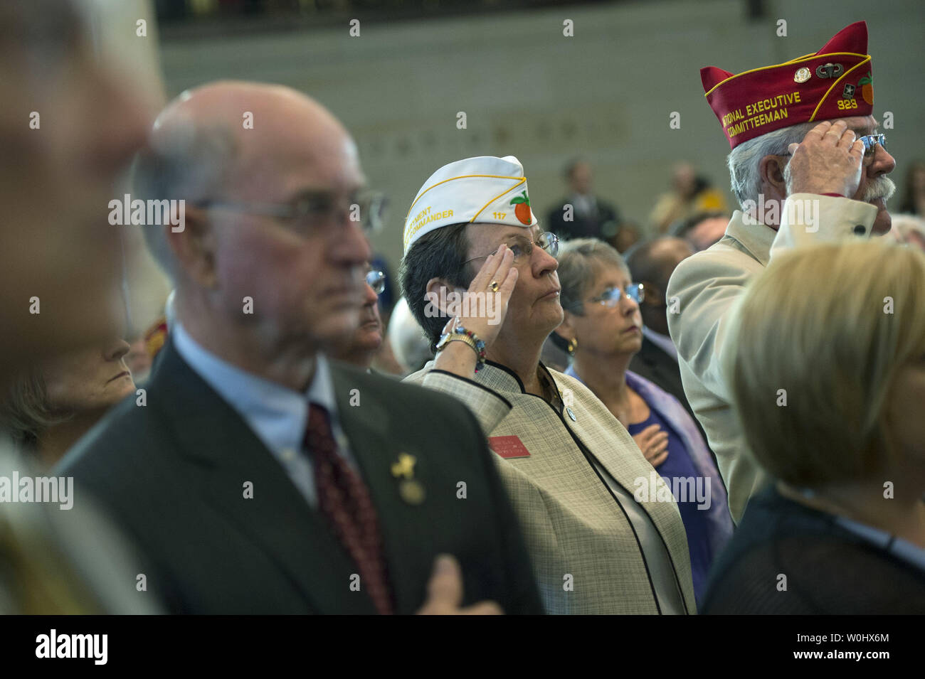 Attendees and Vietnam War veterans stand for the National Anthem during the Congressional Commemoration Ceremony in honor of the 50th anniversary of the Vietnam War, on Capitol Hill in Washington, D.C. on July 8, 2015.  Photo by Kevin Dietsch/UPI Stock Photo