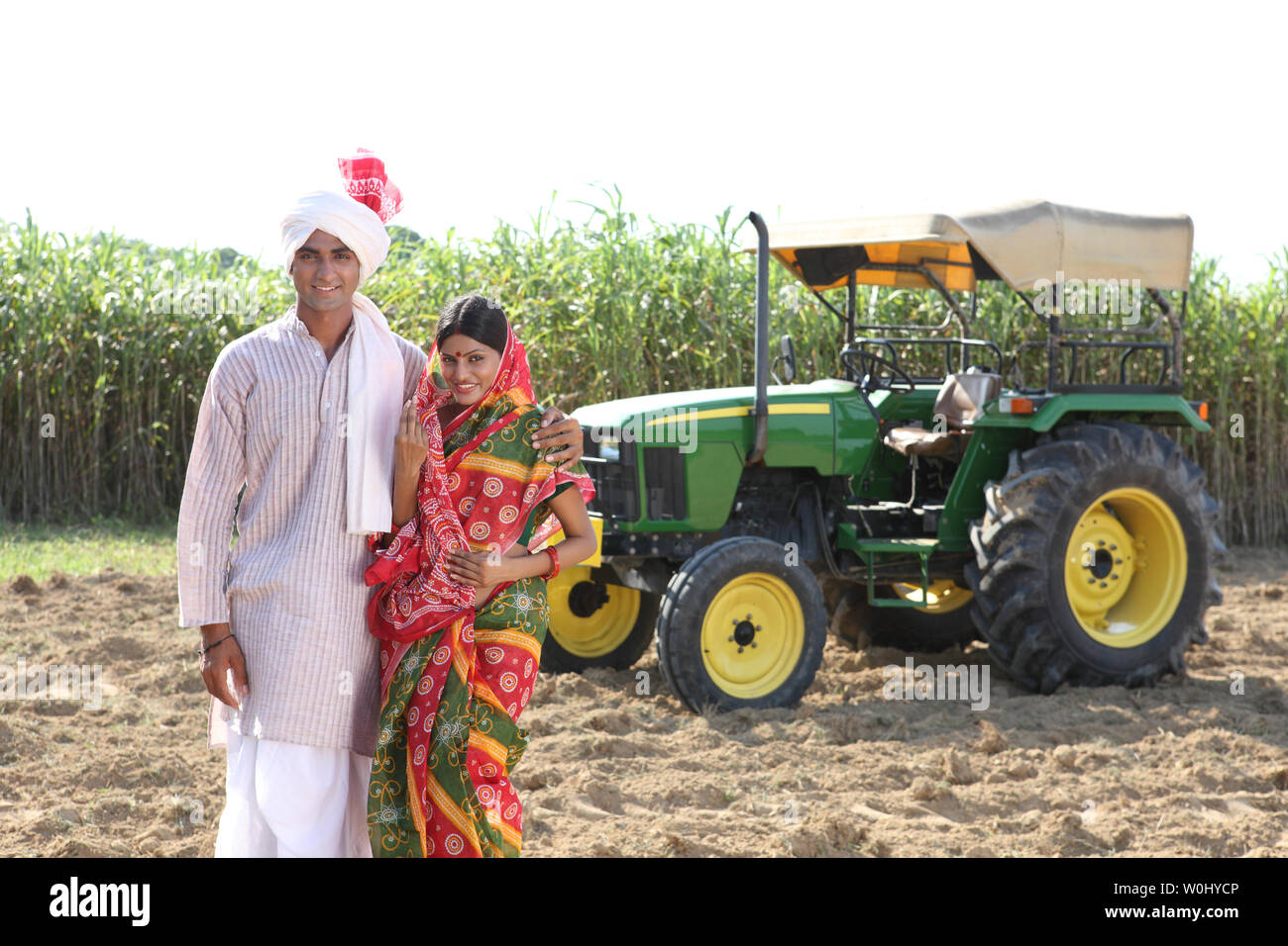 Portrait of a farmer standing with his wife in a field Stock Photo - Alamy