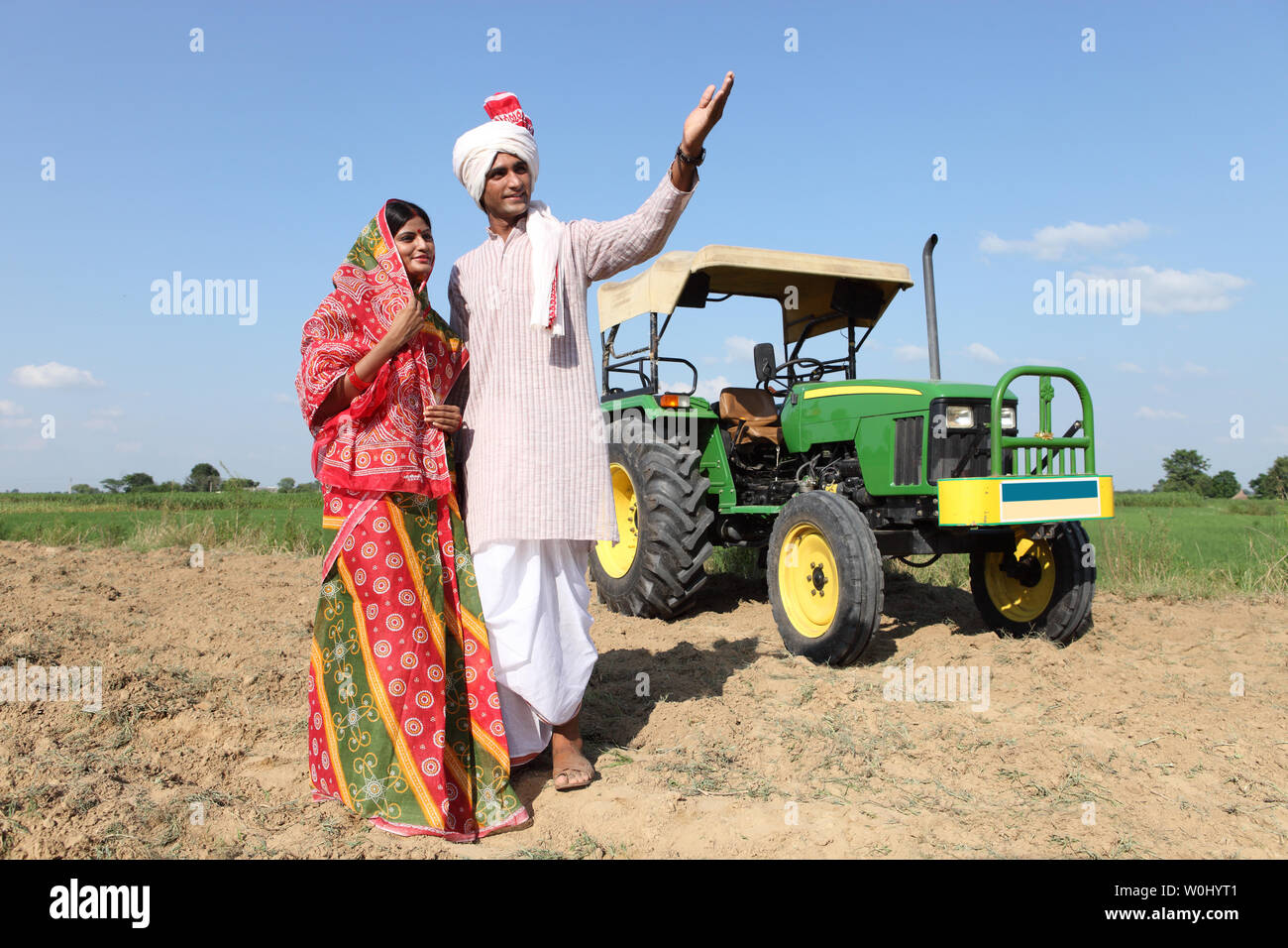 Farmer standing in a field with his wife Stock Photo - Alamy